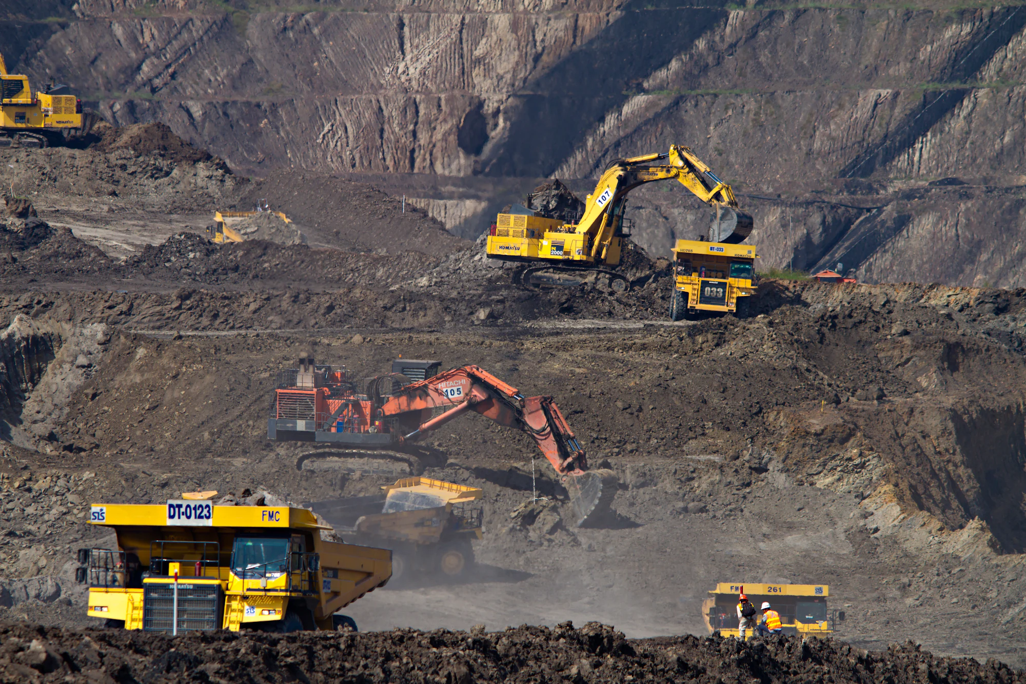 Excavators working the benches of an open pit mine