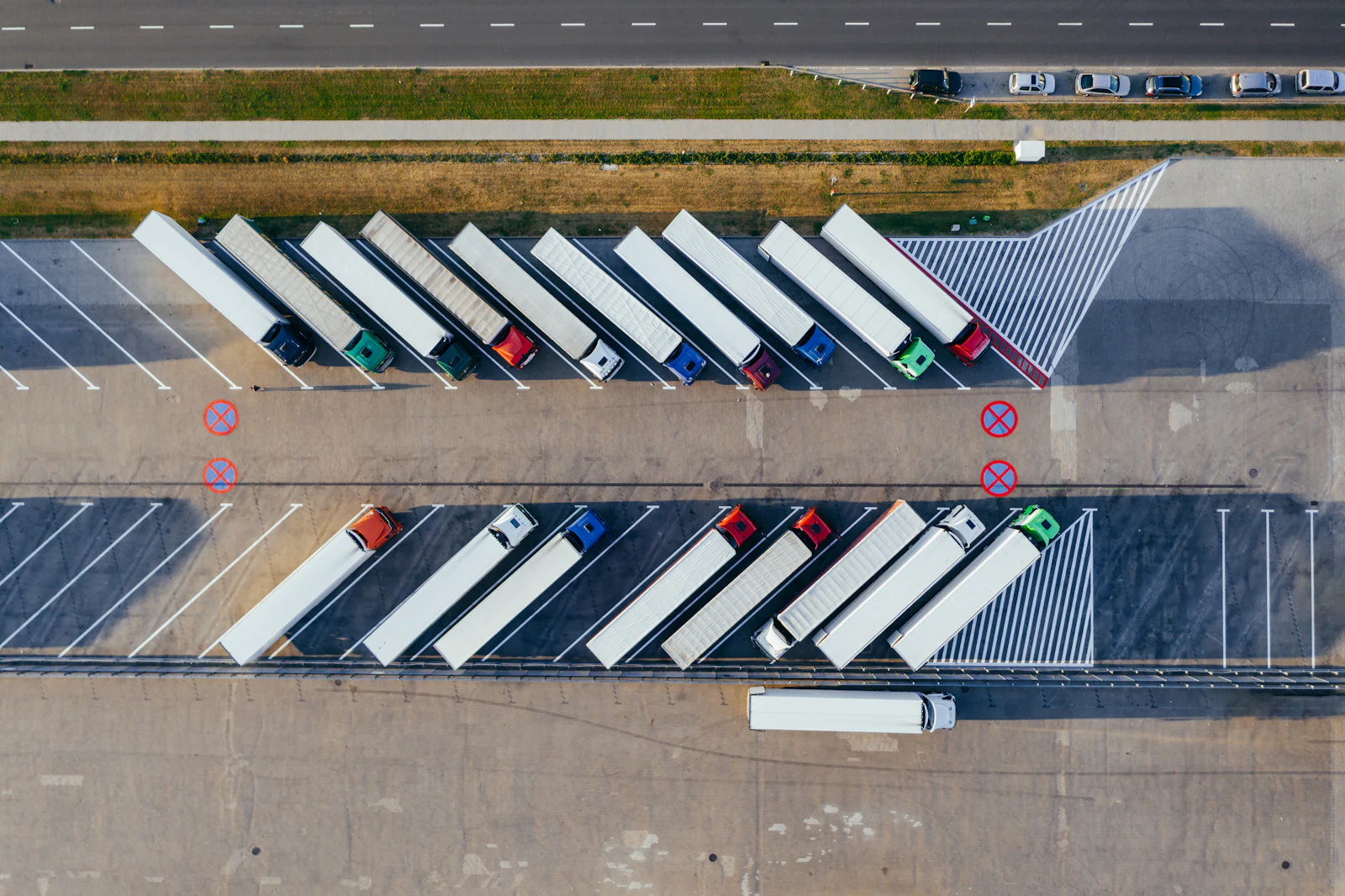 Freight trucks lined up at a logistics hub, seen from above