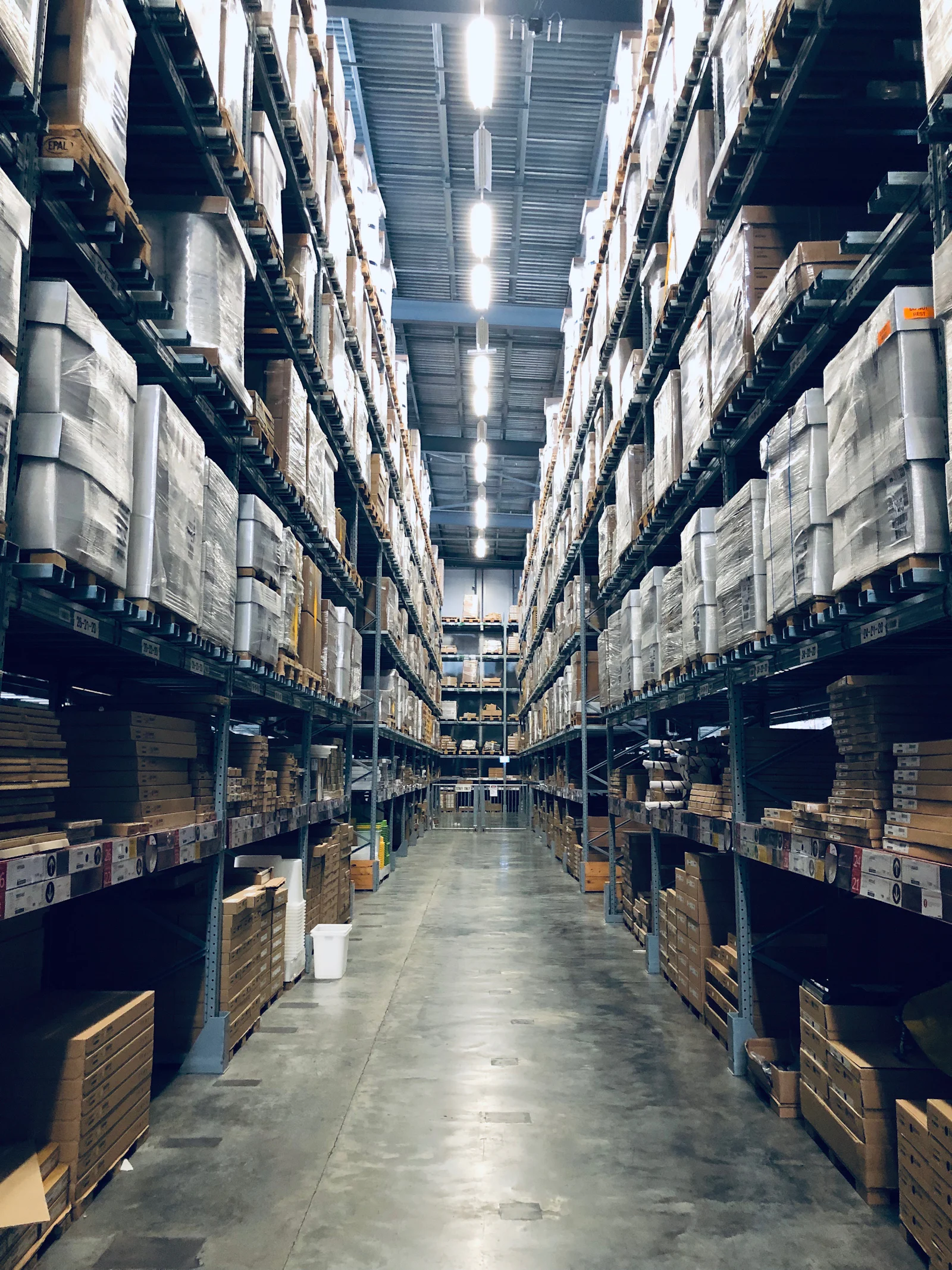 High bay warehouse aisle stocked with palletised material