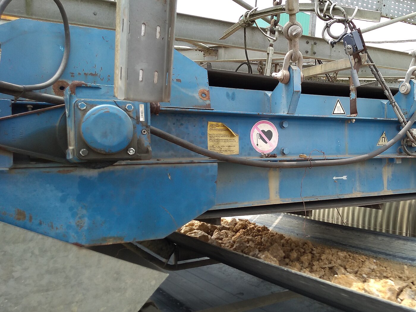 Overbelt magnetic separator above a conveyor at a cement plant